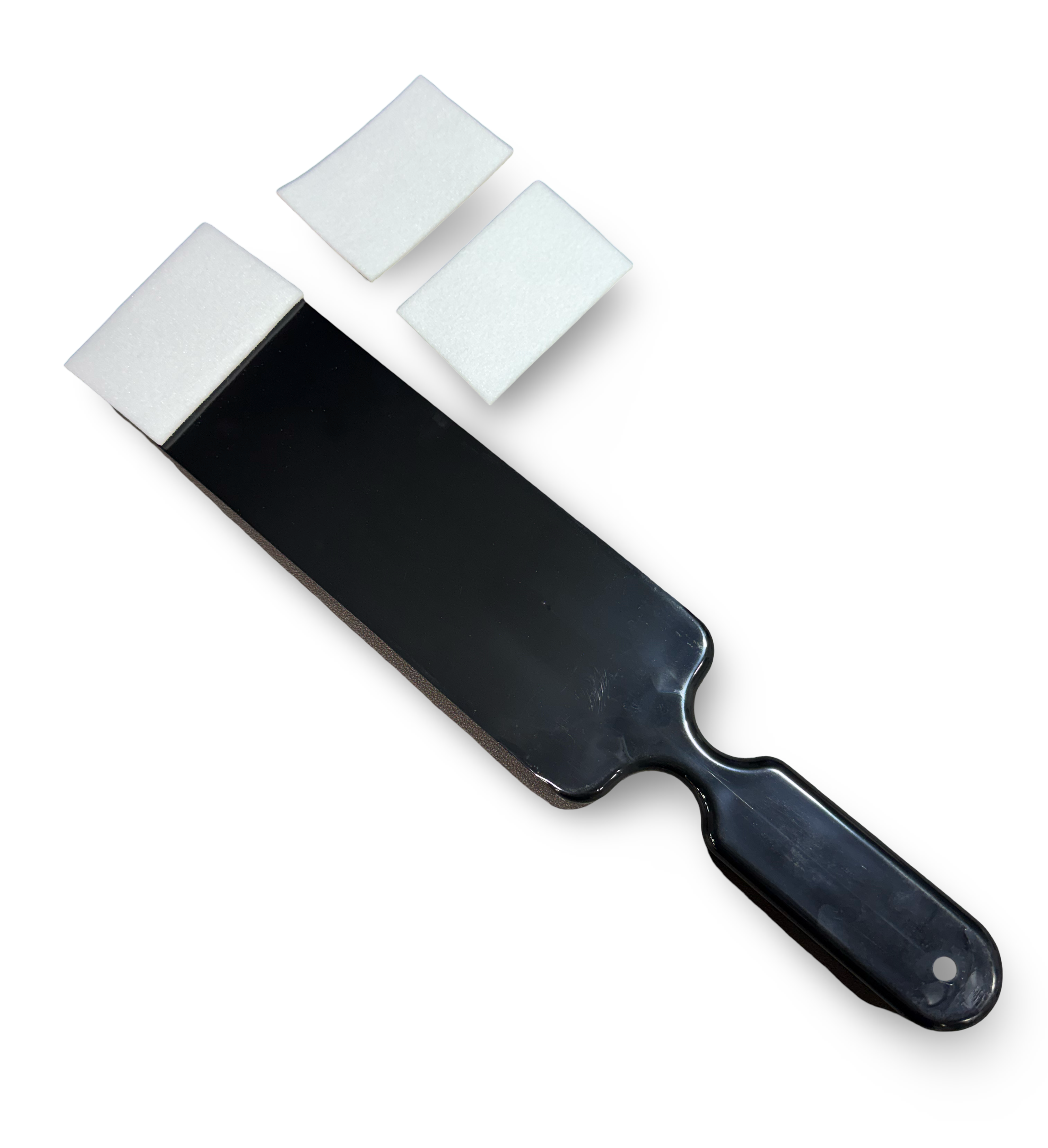 Black paddle with three white squares on a white background